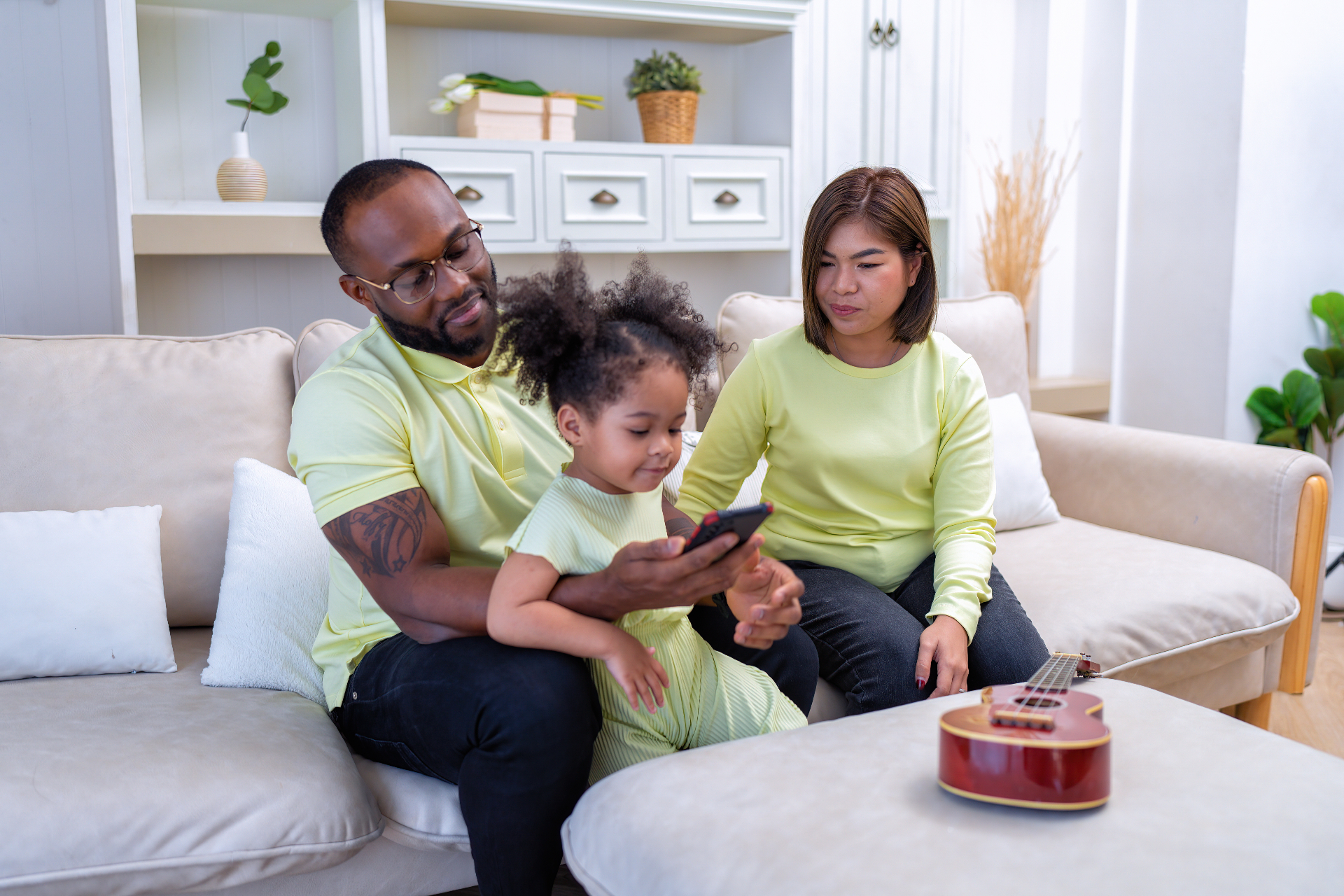 Parents and kids listening together on the couch at home